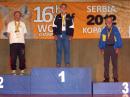 Bob Cooley, KF6VSE, listens to The Star Spangled Banner and wears his gold medal after winning the 2 meter ARDF competition in M70 category. Cooley also won two gold medals and one bronze medal in the ARDF World Cup. [Jay Hennigan, WB6RDV, photo]