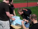 The K2GXT team finishes assembling the foam-encased payload before launch. [Bryce Salmi, KB1LQC, Photo]
