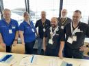 An ARRL VEC administered exam session was held during the convention in Germany, supporting visitors seeking prepared to take their US Amateur Radio Service license exams. The ARRL VE team included (left to right) Manfred Lauterborn, K2PZ; Vivien Lauterborn, KD5VL; Frank Kosidowski, K6OE; Jean-Luc Missler, AK8DX; Timothy Sass, KD8BLT, and Charlie Balla, AC8QT. [Bob Inderbitzen, NQ1R, photo] 