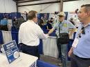 ARRL CEO David Minster, NA2AA, greets ARRL Life Member David Gusman, KC7UI, in the ARRL Exhibit. QST Product Review Editor Pascal Villeneuve, VA2PV, looks on.