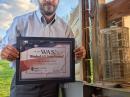 Eric Tichansky, NO3M, with his ARRL Worked All States certificate near his antenna. 