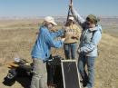 MDRS Crew 69 Communications Engineer Andrea Hartlage, KG4IUM; Commander Emily Colvin, KI4MSM, and Crew Engineer Elisha Sanders, KJ4CQM, erect the j-pole and mast used with the digipeater. [Dan Crowley, KJ4CQI, Photo]