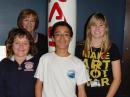 Back: Cyndy Moriarty, K9CMM; front, from left: ISS student operators: Brianna Edgemon, Blair Francis and Heather Gregory. The group poses for a victory photo celebrating their ISS experience in the dome at the Challenger Center.